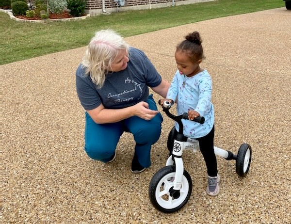 Toddler with Down syndrome receives tricycle that was donated to The Warren Center