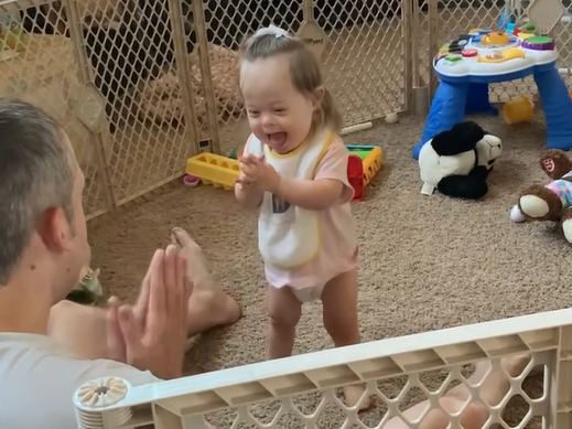 Toddler with Down syndrome stands up on her own